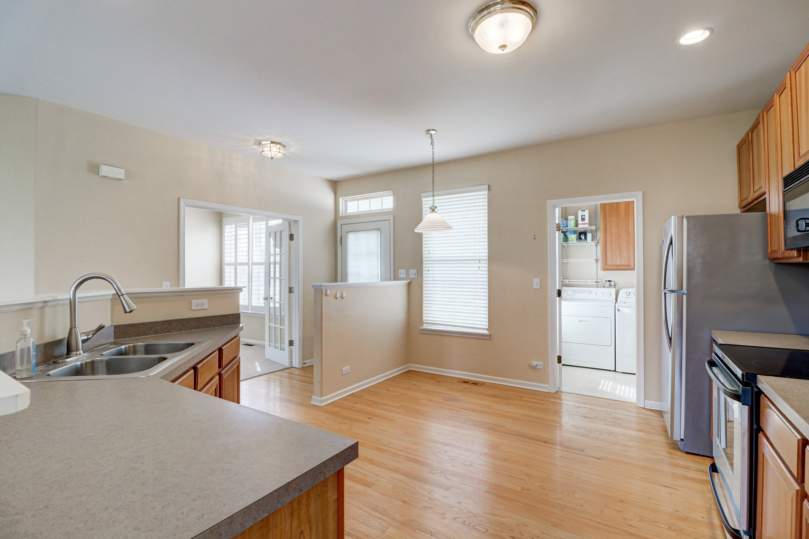 32670 Innetowne Road Lakemoor, IL 60051 - Photo 9 of 25 a kitchen with stainless steel appliances granite countertop a sink stove and refrigerator