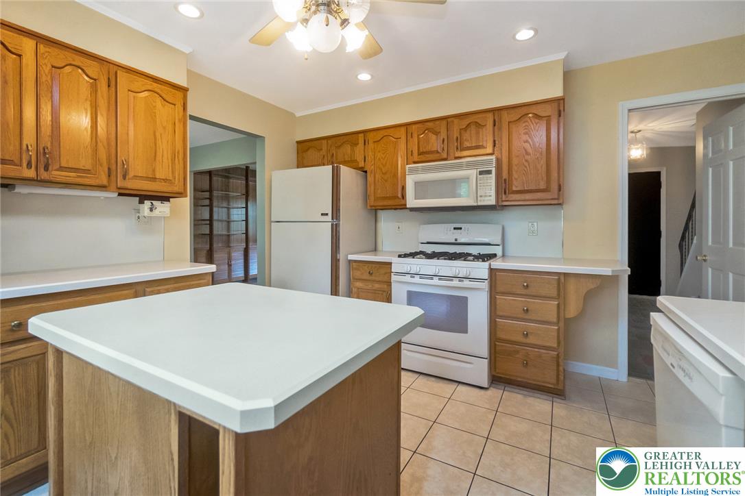 268 Apollo Drive Bethlehem, PA 18017 - Photo 12 of 56 A fully equipped kitchen features a central island, ample wood cabinetry, ceramic tile floor and complete appliance package ready for culinary endeavors.