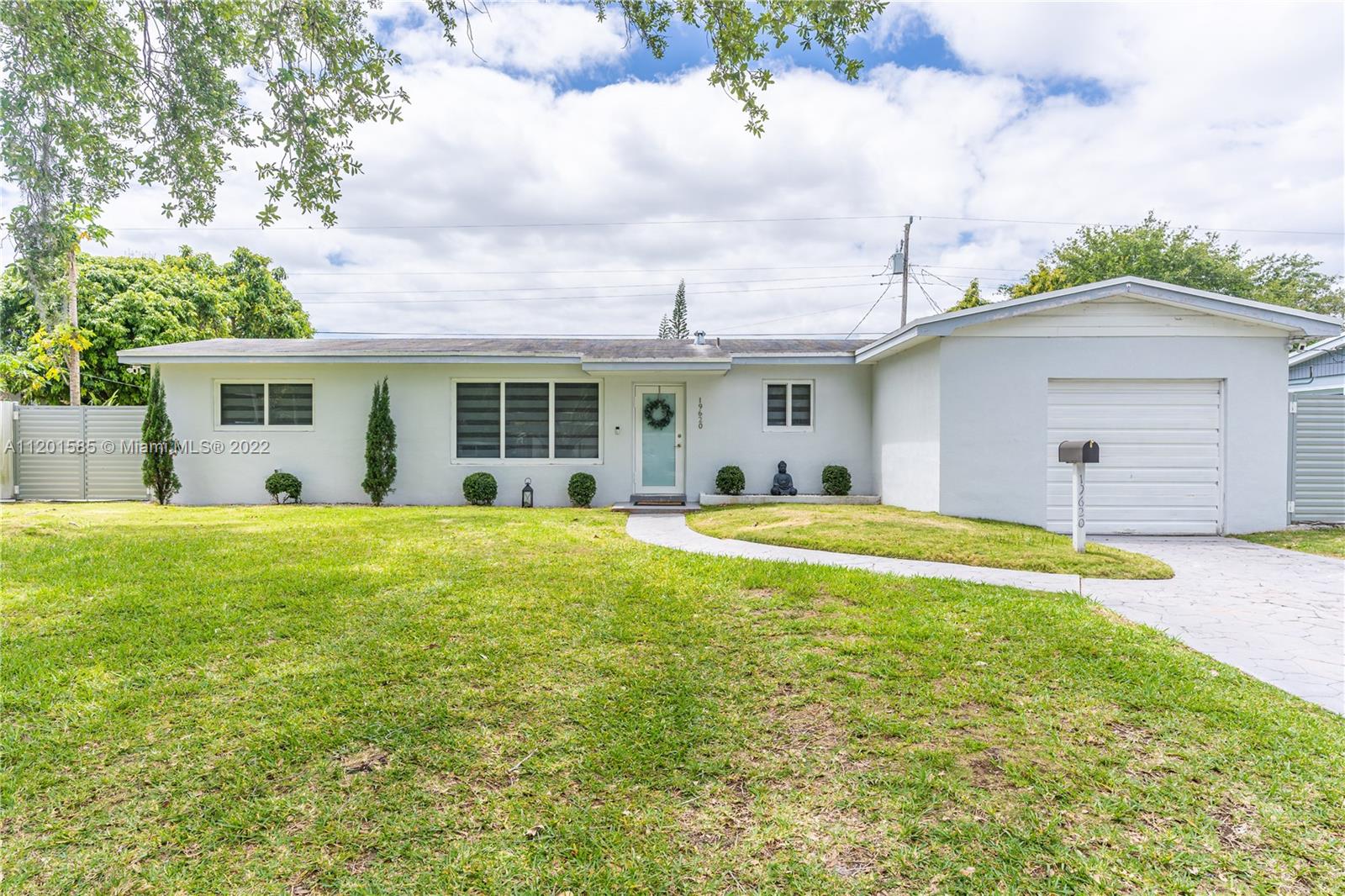 19620 Franjo Road Cutler Bay, FL 33157 - Photo 1 of 28 a view of a white house with a swimming pool and a yard