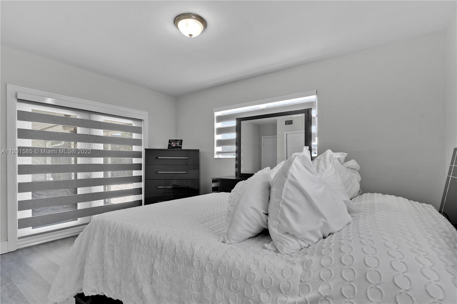 19620 Franjo Road Cutler Bay, FL 33157 - Photo 17 of 28 a bedroom with a bed and a cabinets
