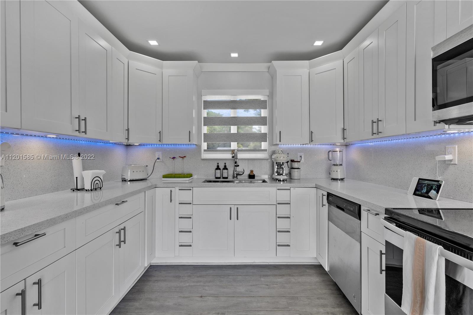 19620 Franjo Road Cutler Bay, FL 33157 - Photo 9 of 28 a kitchen with white cabinets stainless steel appliances and sink