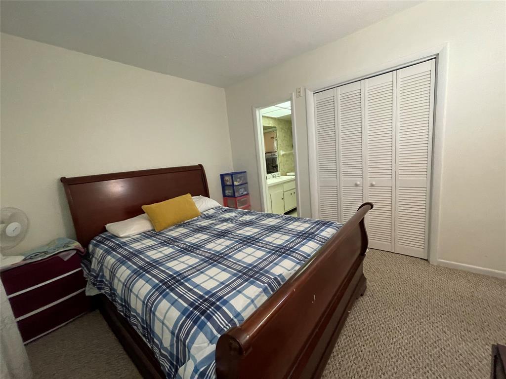 2851 East Golf Boulevard, Unit 206 Pompano Beach, FL 33064 - Photo 12 of 35 a bed sitting in a bedroom next to a window