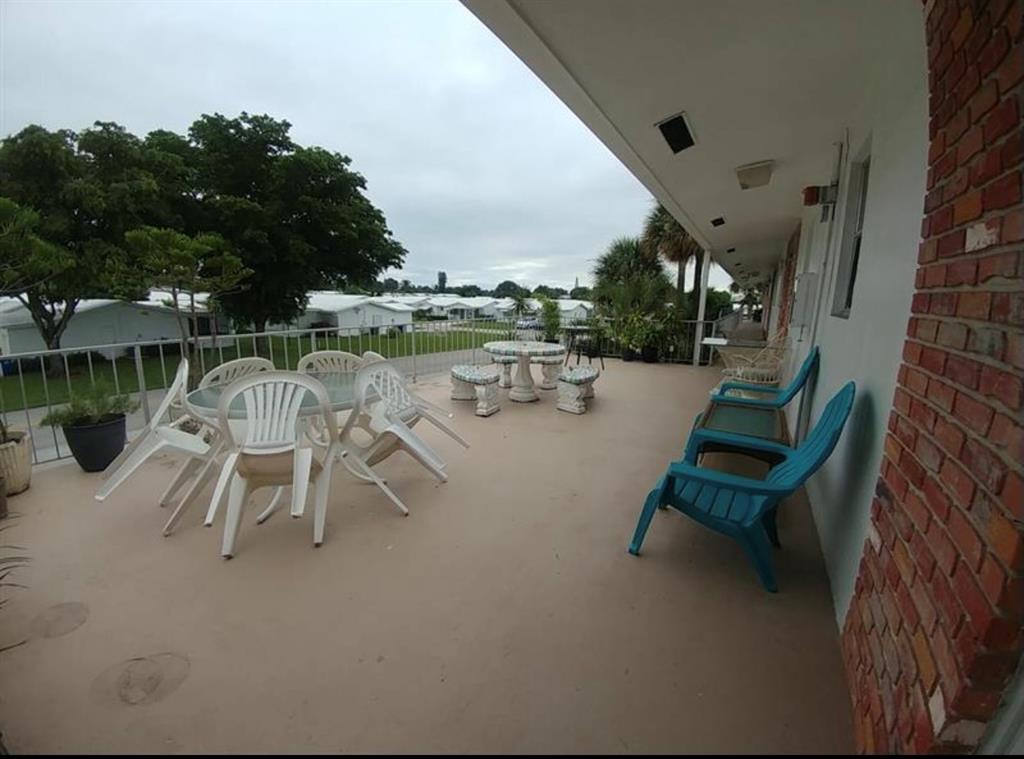 2851 East Golf Boulevard, Unit 206 Pompano Beach, FL 33064 - Photo 22 of 35 a view of a swimming pool with a lounge chair