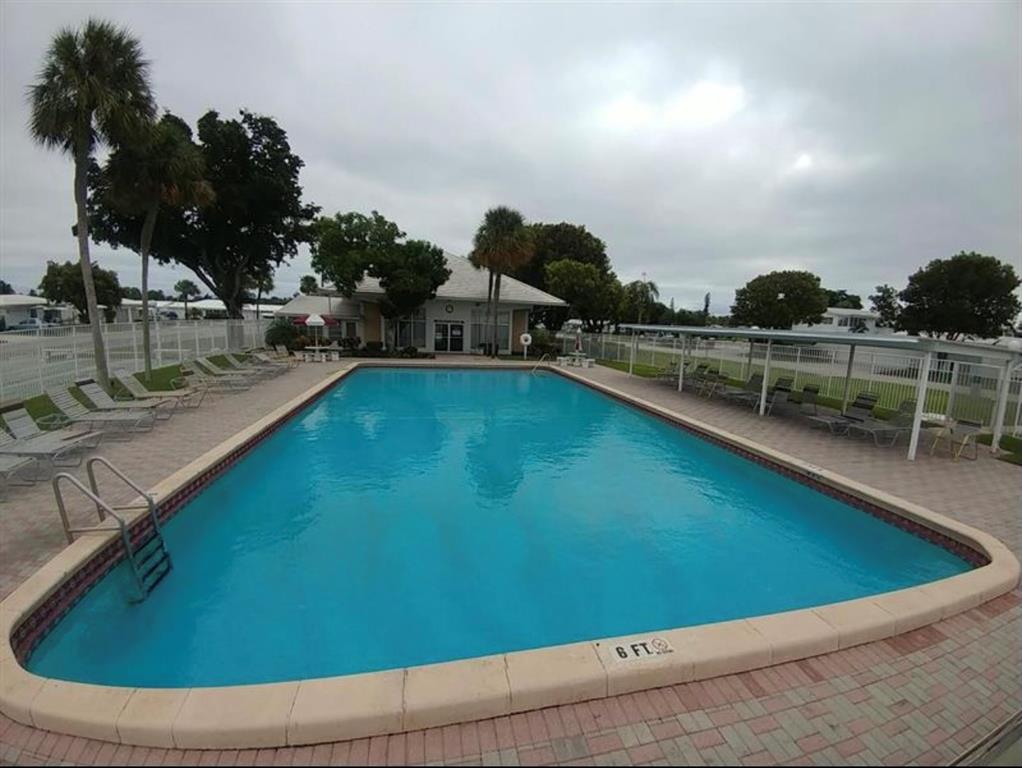 2851 East Golf Boulevard, Unit 206 Pompano Beach, FL 33064 - Photo 27 of 35 a view of swimming pool with outdoor seating