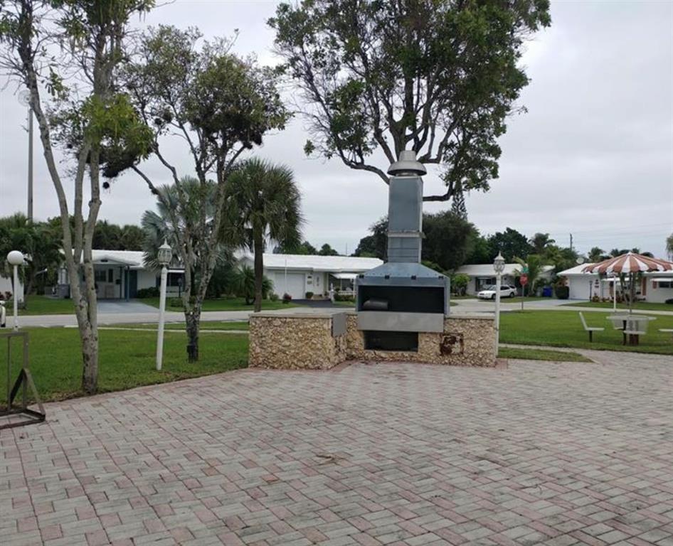 2851 East Golf Boulevard, Unit 206 Pompano Beach, FL 33064 - Photo 35 of 35 a view of a house with outdoor space and sitting area