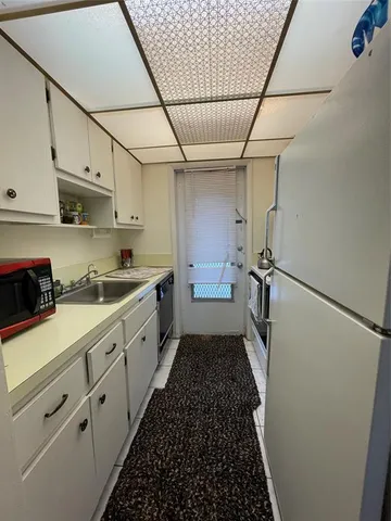 a kitchen with stainless steel appliances granite countertop white cabinets and a stove