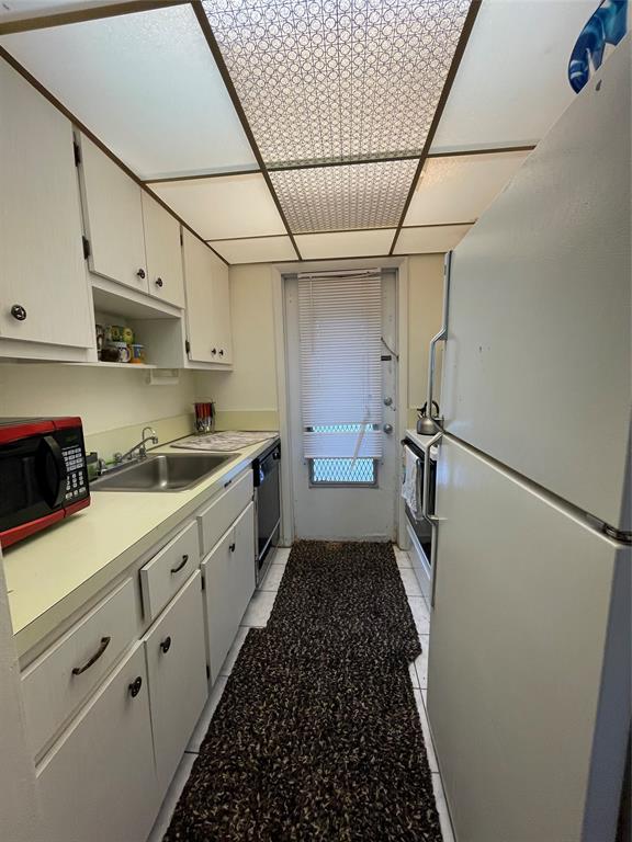 2851 East Golf Boulevard, Unit 206 Pompano Beach, FL 33064 - Photo 8 of 35 a kitchen with stainless steel appliances a refrigerator sink and cabinets