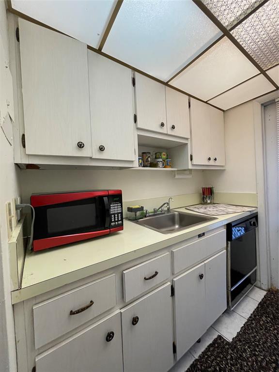 2851 East Golf Boulevard, Unit 206 Pompano Beach, FL 33064 - Photo 9 of 35 a kitchen with stainless steel appliances granite countertop white cabinets and a stove