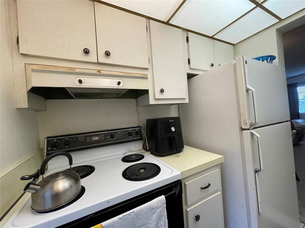 2851 East Golf Boulevard, Unit 206 Pompano Beach, FL 33064 - Photo 10 of 35 a kitchen with a refrigerator and a stove