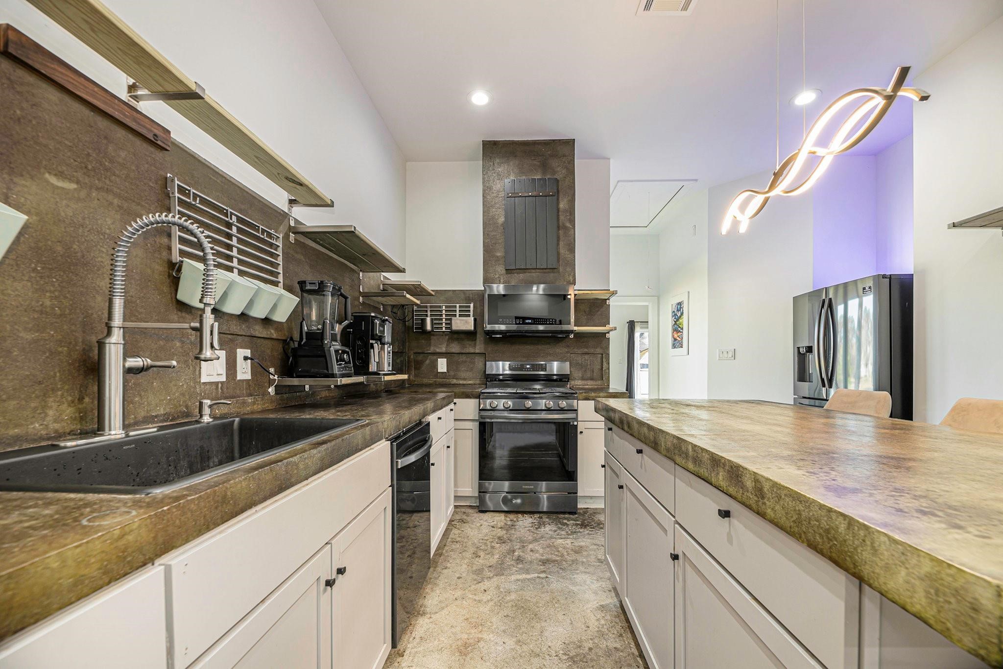 475 Pinnacle Trinity, TX 75862 - Photo 15 of 23 a kitchen with stainless steel appliances granite countertop a sink and stove
