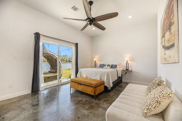 an empty room with a ceiling fan and a window