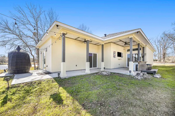 a swimming pool with outdoor seating and barbeque oven