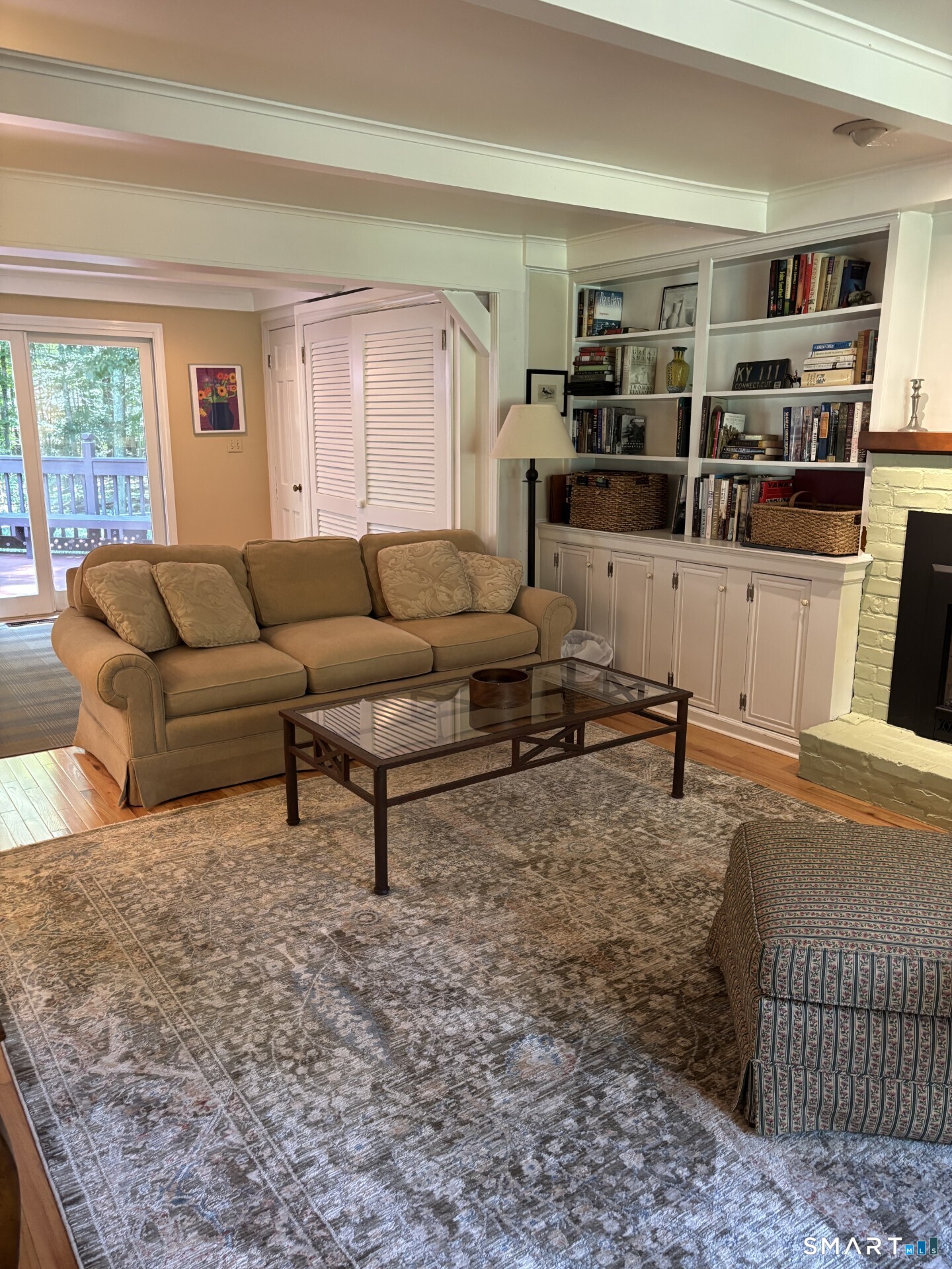 20 Godman Road Madison, CT 06443 - Photo 7 of 29 Family Room with gas fireplace opens to kitchen and dining area.