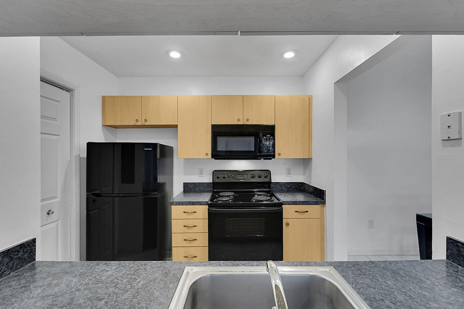 2698 North Nob Hill Road Sunrise, FL 33322 - Photo 7 of 27 a kitchen with a refrigerator and a stove top oven
