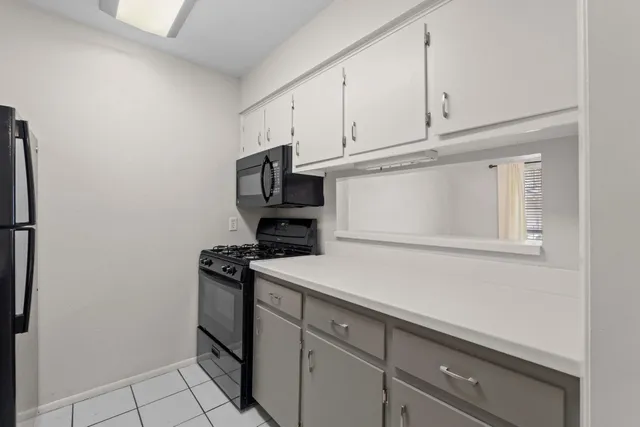 a utility room with cabinets washer and dryer
