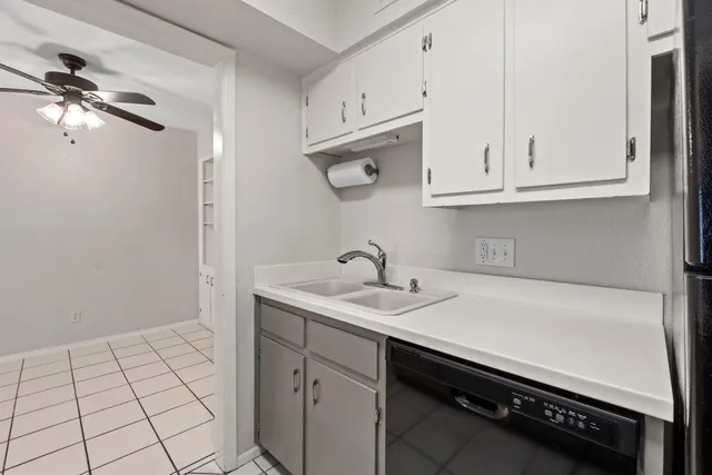 a kitchen with a sink cabinets and a window