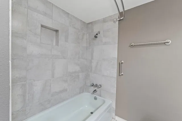 a bathroom with a bathtub and shower