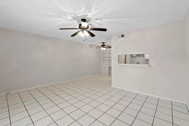 a view of a room with window and ceiling fan