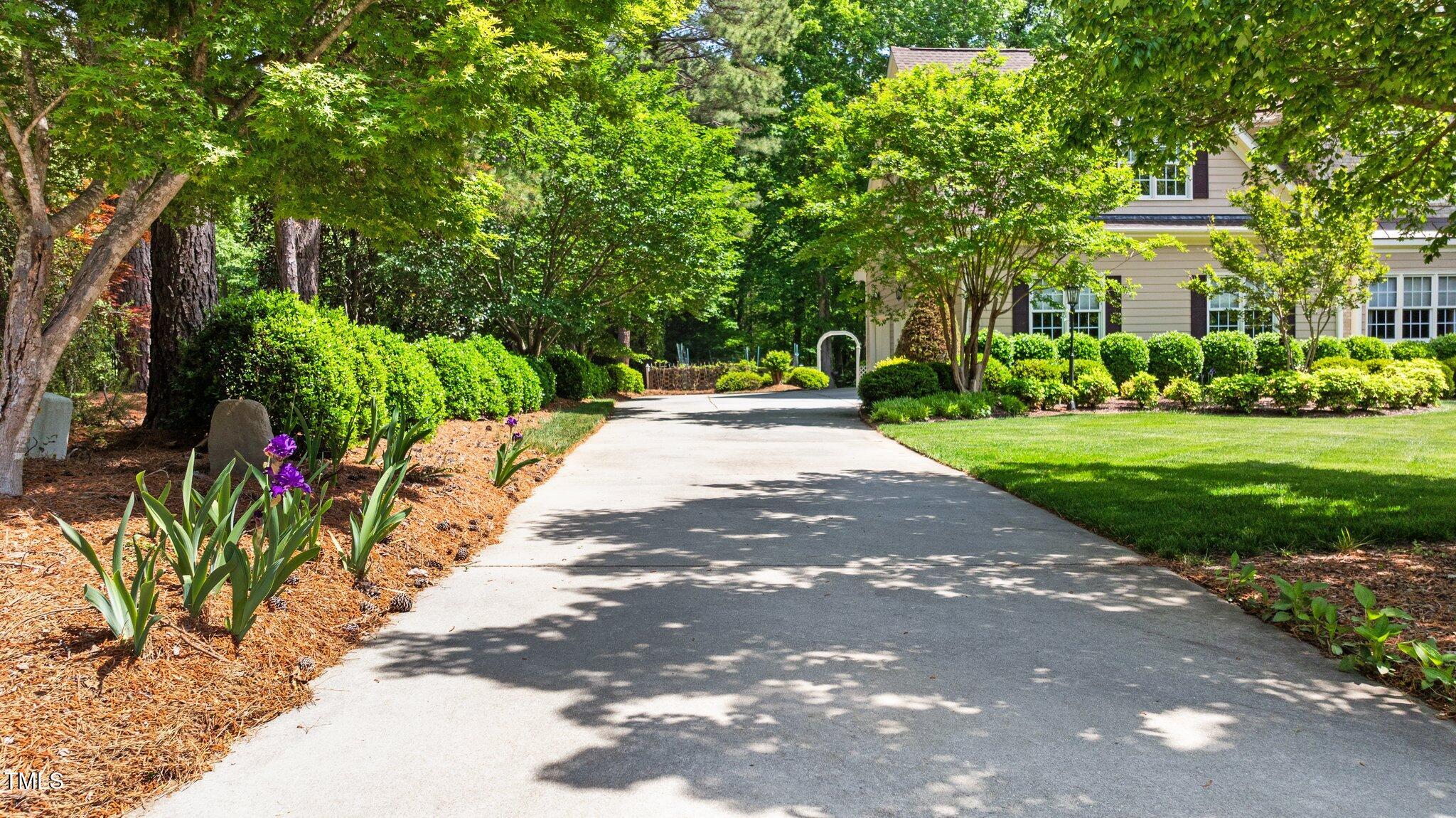 7212 Donneeford Road Wake Forest, NC 27587 - Photo 38 of 51 Driveway lined with flowers