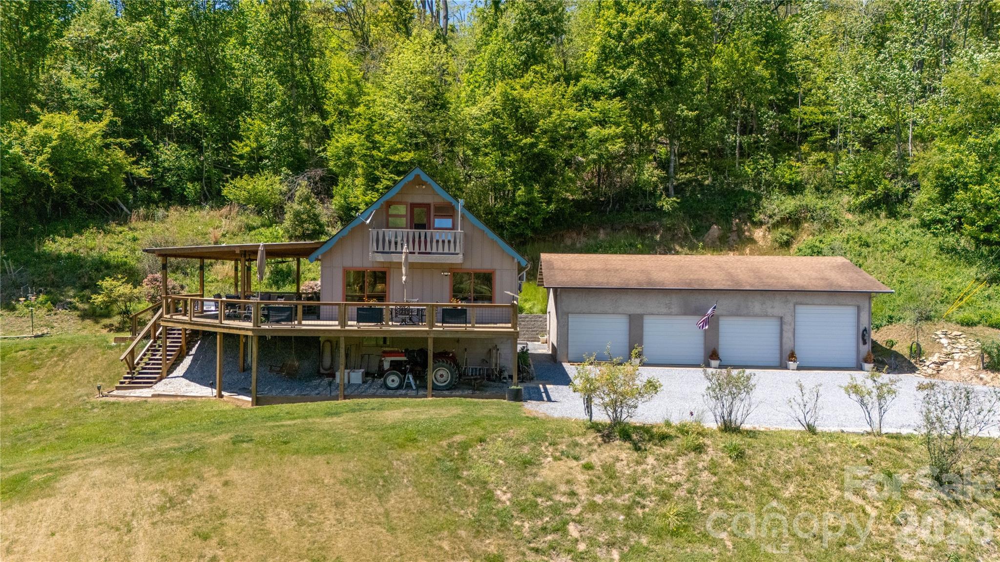 93 Franklin Crest Road Spruce Pine, NC 28777 - Photo 2 of 47 a view of a house with a big yard and large trees