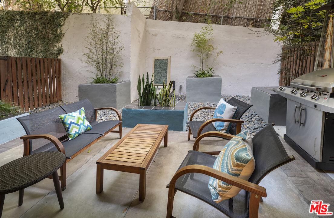 11687 Bellagio Road, Unit 3 Los Angeles, CA 90049 - Photo 1 of 31 a view of a patio with couple of chairs