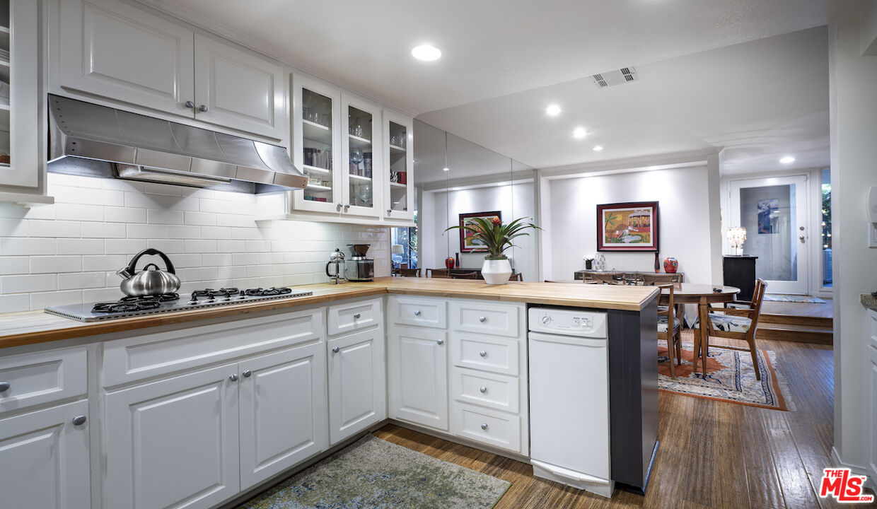 11687 Bellagio Road, Unit 3 Los Angeles, CA 90049 - Photo 12 of 31 a kitchen with cabinets and window