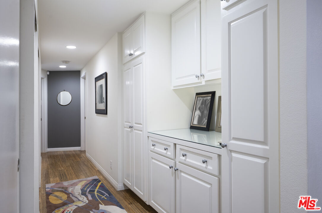 11687 Bellagio Road, Unit 3 Los Angeles, CA 90049 - Photo 18 of 31 a view of cabinets with wooden floor