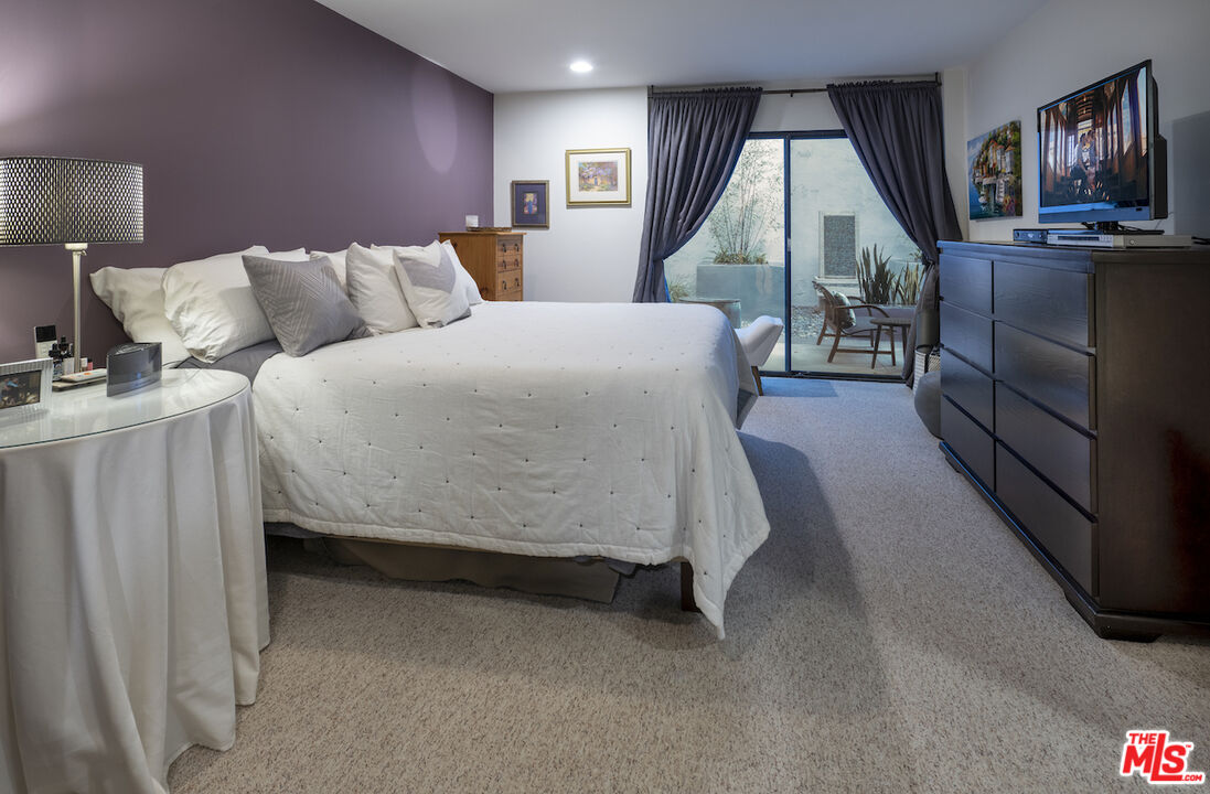 11687 Bellagio Road, Unit 3 Los Angeles, CA 90049 - Photo 19 of 31 a bed room with a bed and a television