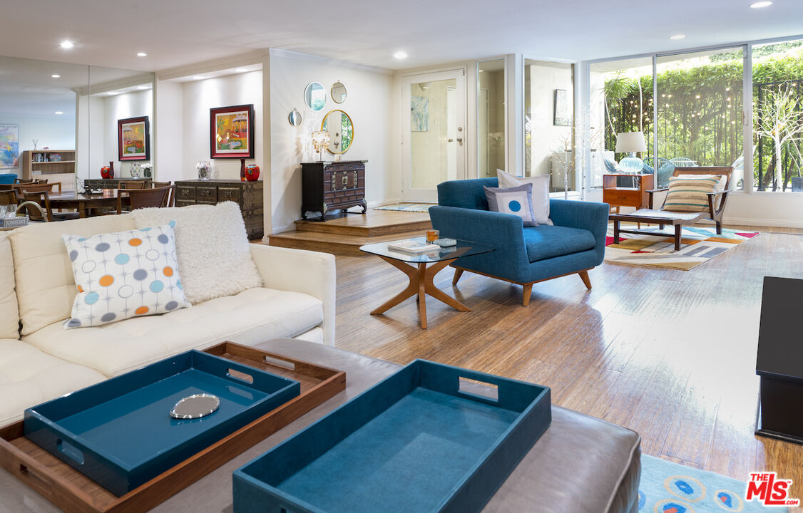 11687 Bellagio Road, Unit 3 Los Angeles, CA 90049 - Photo 2 of 31 a living room with furniture and a flat screen tv
