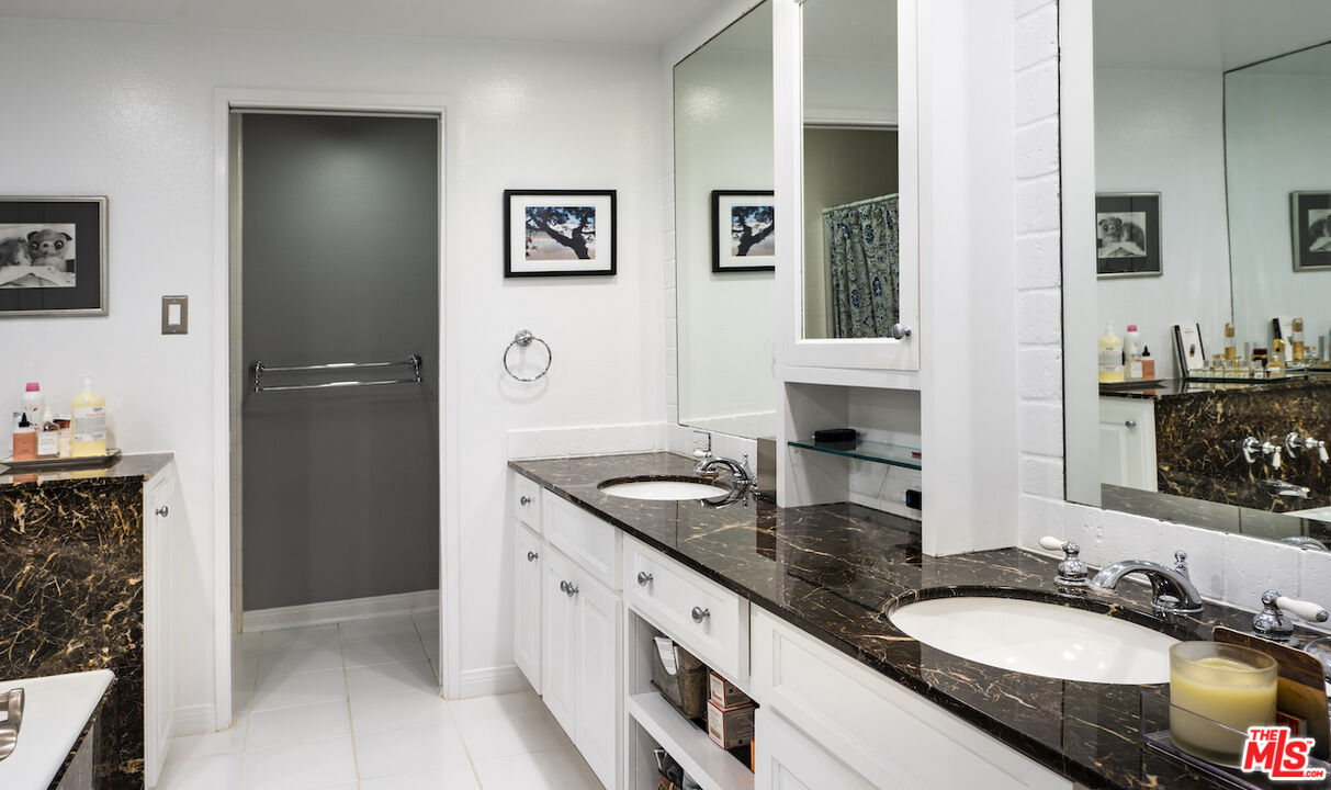 11687 Bellagio Road, Unit 3 Los Angeles, CA 90049 - Photo 22 of 31 a bathroom with double vanity and a mirror