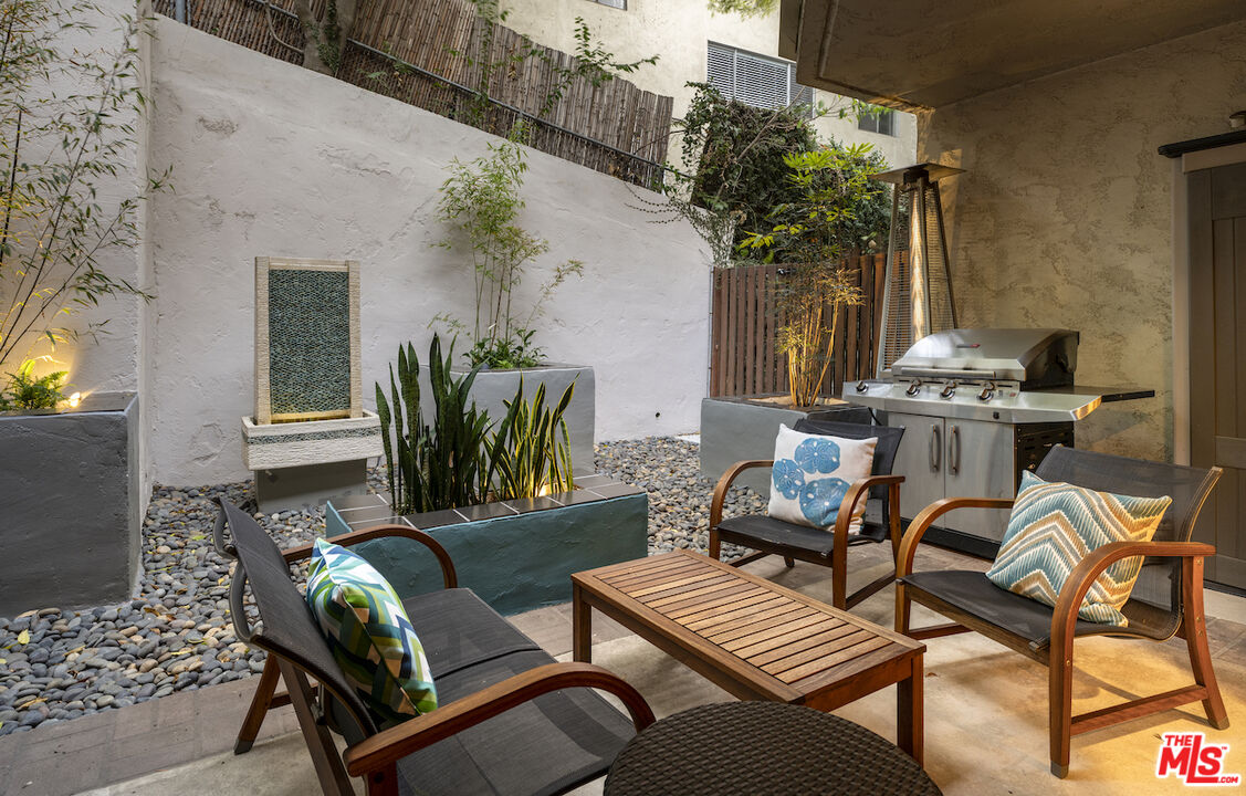 11687 Bellagio Road, Unit 3 Los Angeles, CA 90049 - Photo 25 of 31 a view of a house with backyard and sitting area