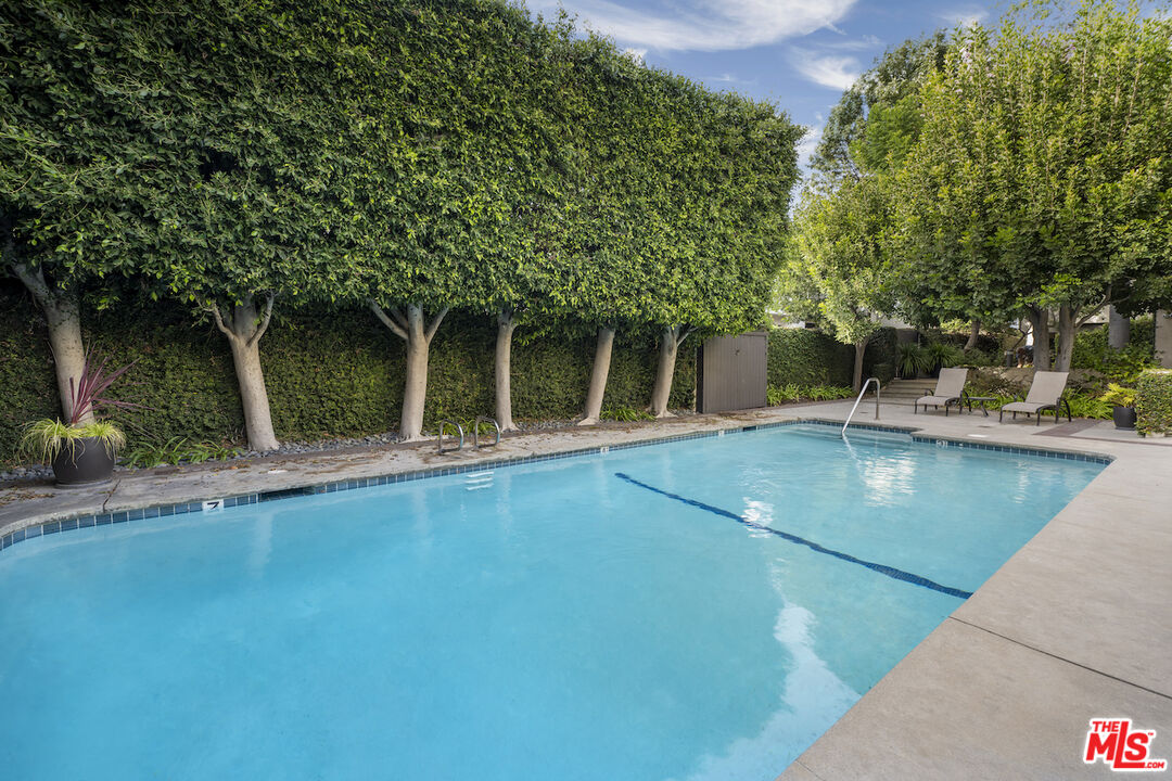 11687 Bellagio Road, Unit 3 Los Angeles, CA 90049 - Photo 27 of 31 a view of a swimming pool with an outdoor seating