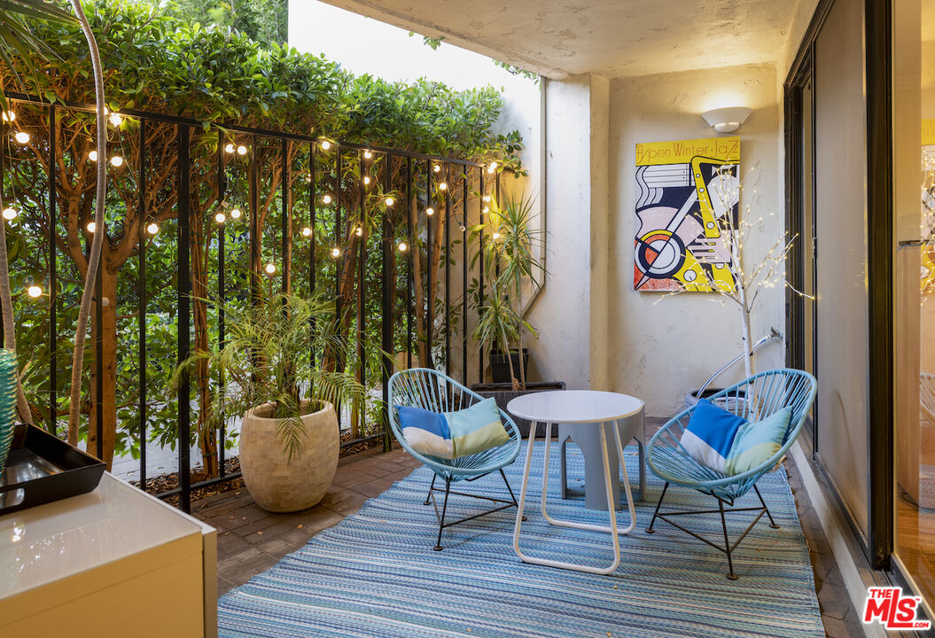11687 Bellagio Road, Unit 3 Los Angeles, CA 90049 - Photo 3 of 31 a outdoor space with chairs