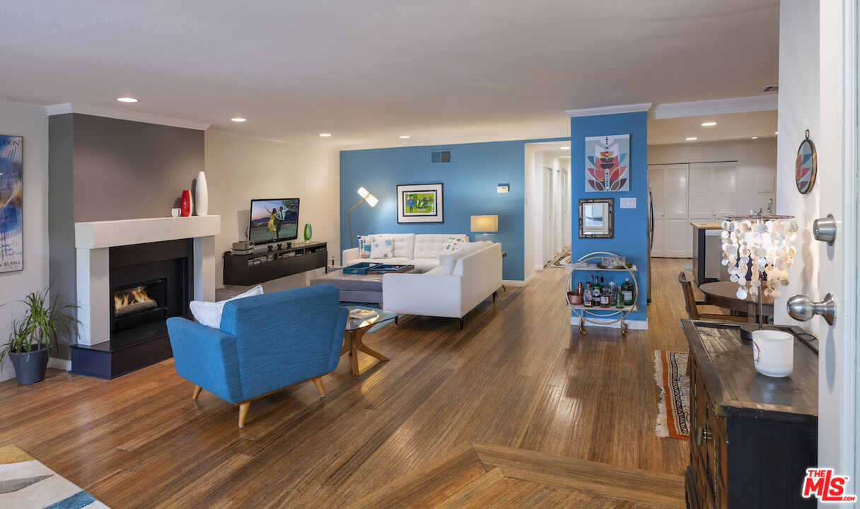 11687 Bellagio Road, Unit 3 Los Angeles, CA 90049 - Photo 5 of 31 a living room with furniture and a fireplace