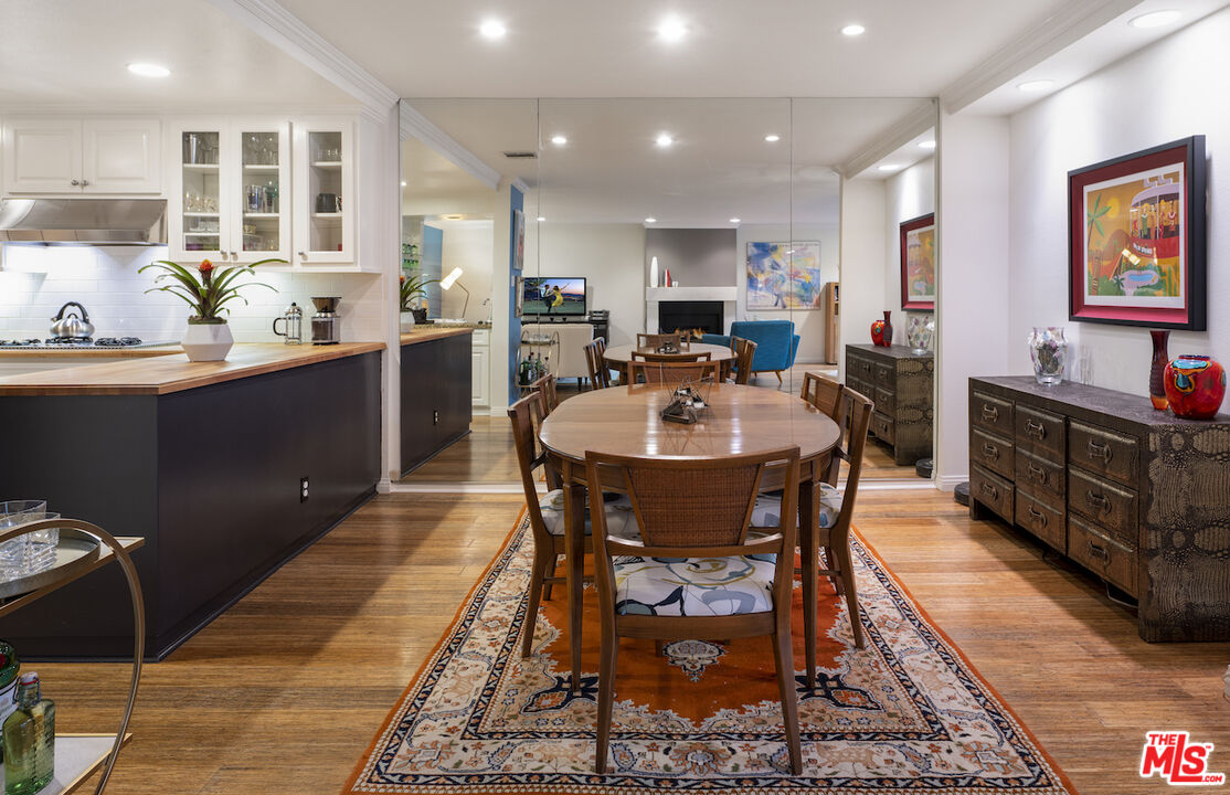 11687 Bellagio Road, Unit 3 Los Angeles, CA 90049 - Photo 10 of 31 a large kitchen with a table and chairs