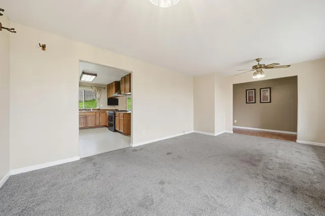 a living room with furniture a flat screen tv and a large window