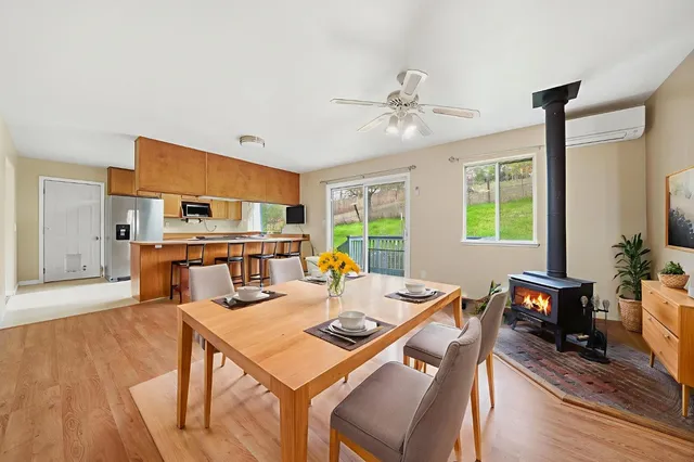 a view of a room with natural light and hardwood floor