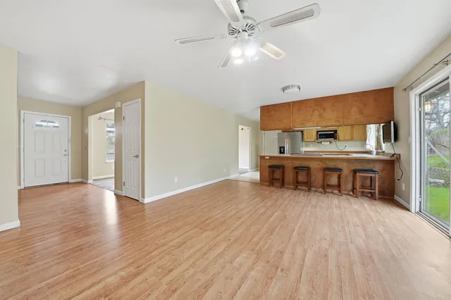 a kitchen with stainless steel appliances granite countertop a sink refrigerator and cabinets