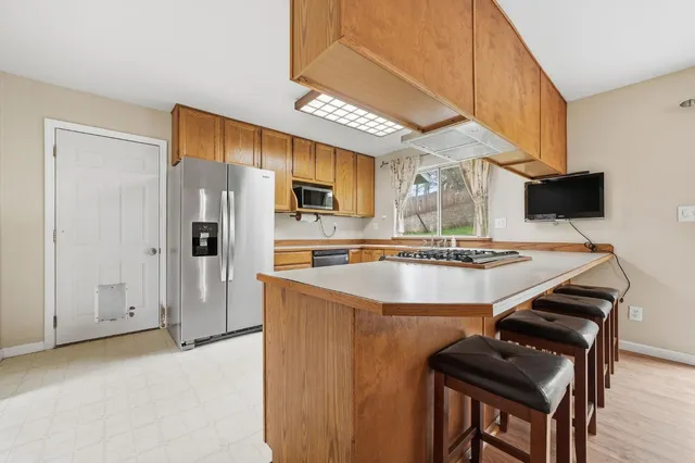 a view of a sink a microwave and outdoor space