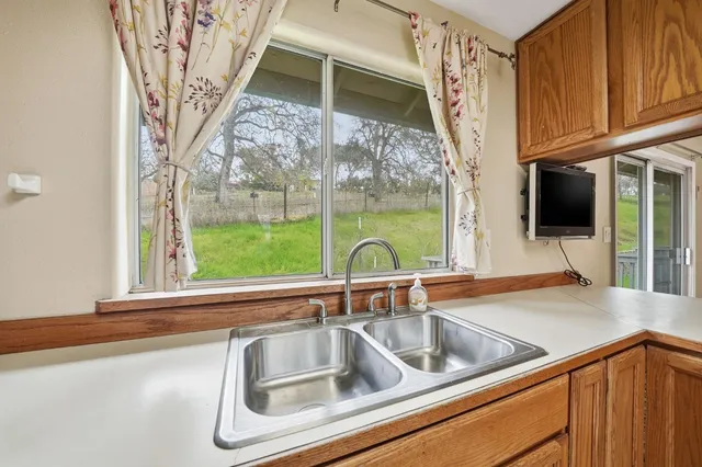 a bathroom with a granite countertop toilet sink and mirror