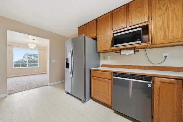 an empty room with ceiling fan and window