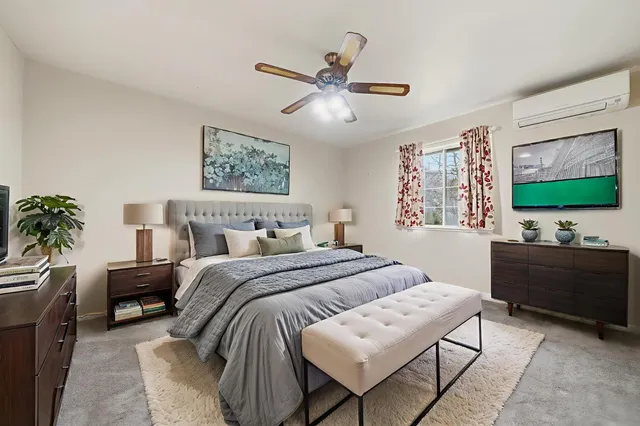 a bedroom with bed and a chandelier