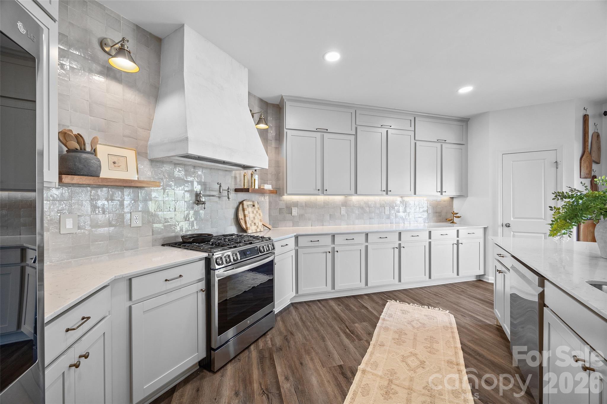 138 Lambeth Loop Mooresville, NC 28115 - Photo 13 of 48 a kitchen with granite countertop white cabinets and white appliances