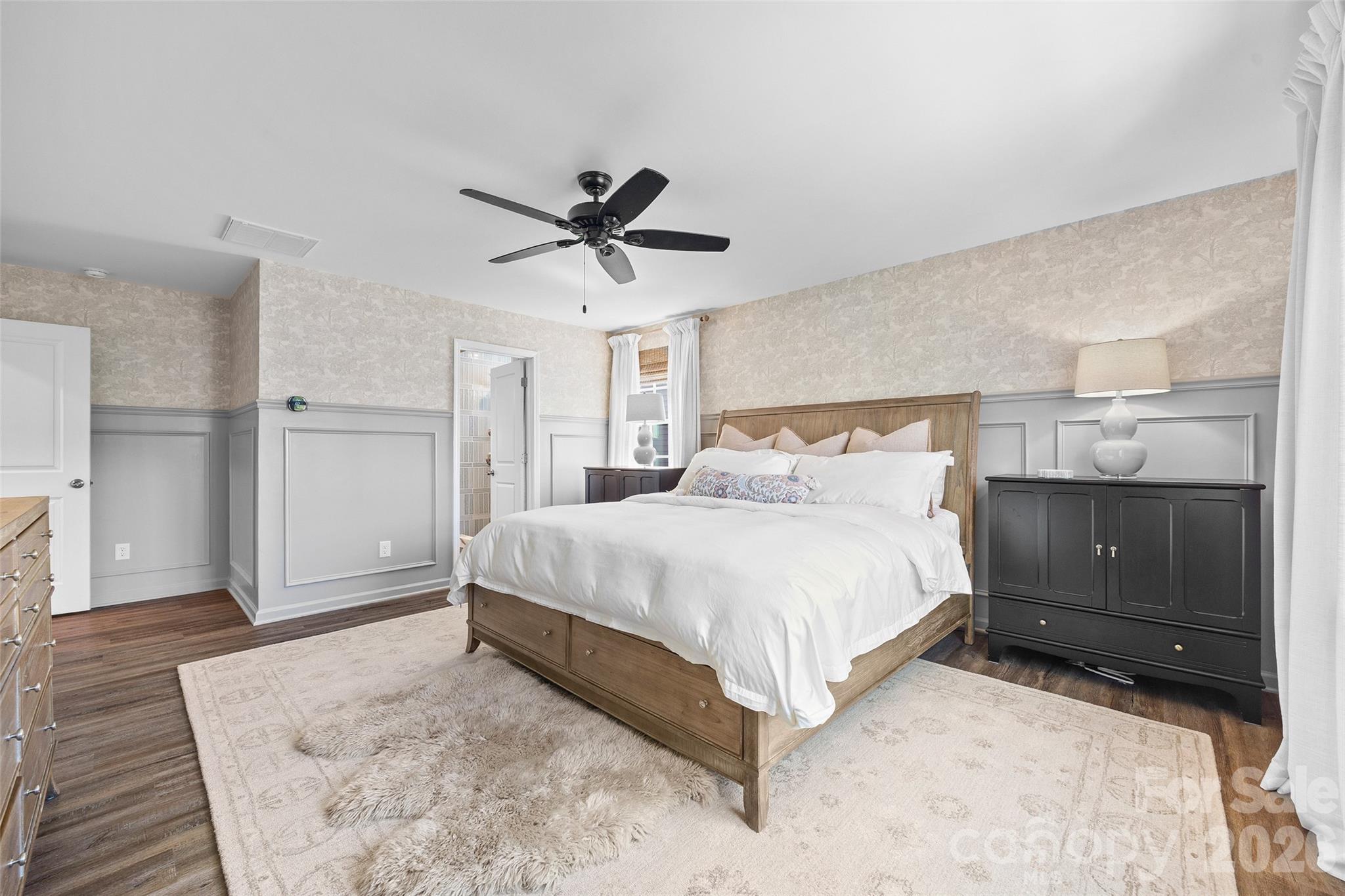 138 Lambeth Loop Mooresville, NC 28115 - Photo 20 of 48 a bedroom with a large bed and a chandelier fan