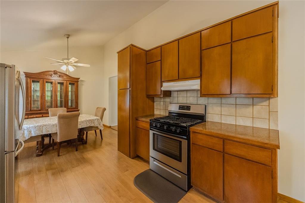 2829 Cardinal Trace Duluth, GA 30096 - Photo 6 of 11 a kitchen with stainless steel appliances a stove a sink cabinets and a dining table