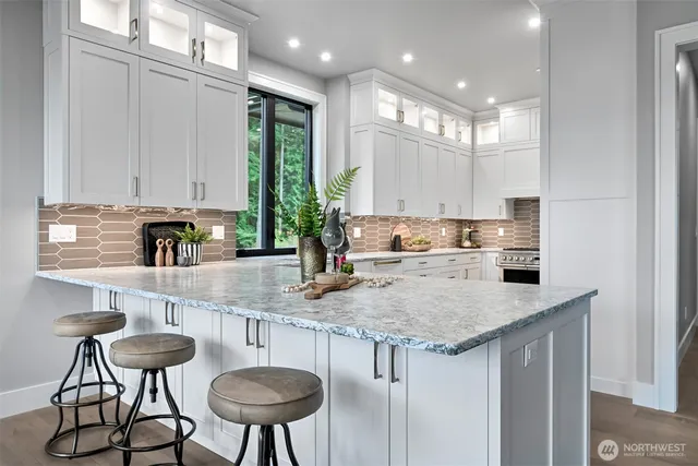 a kitchen with stainless steel appliances granite countertop a sink and a refrigerator