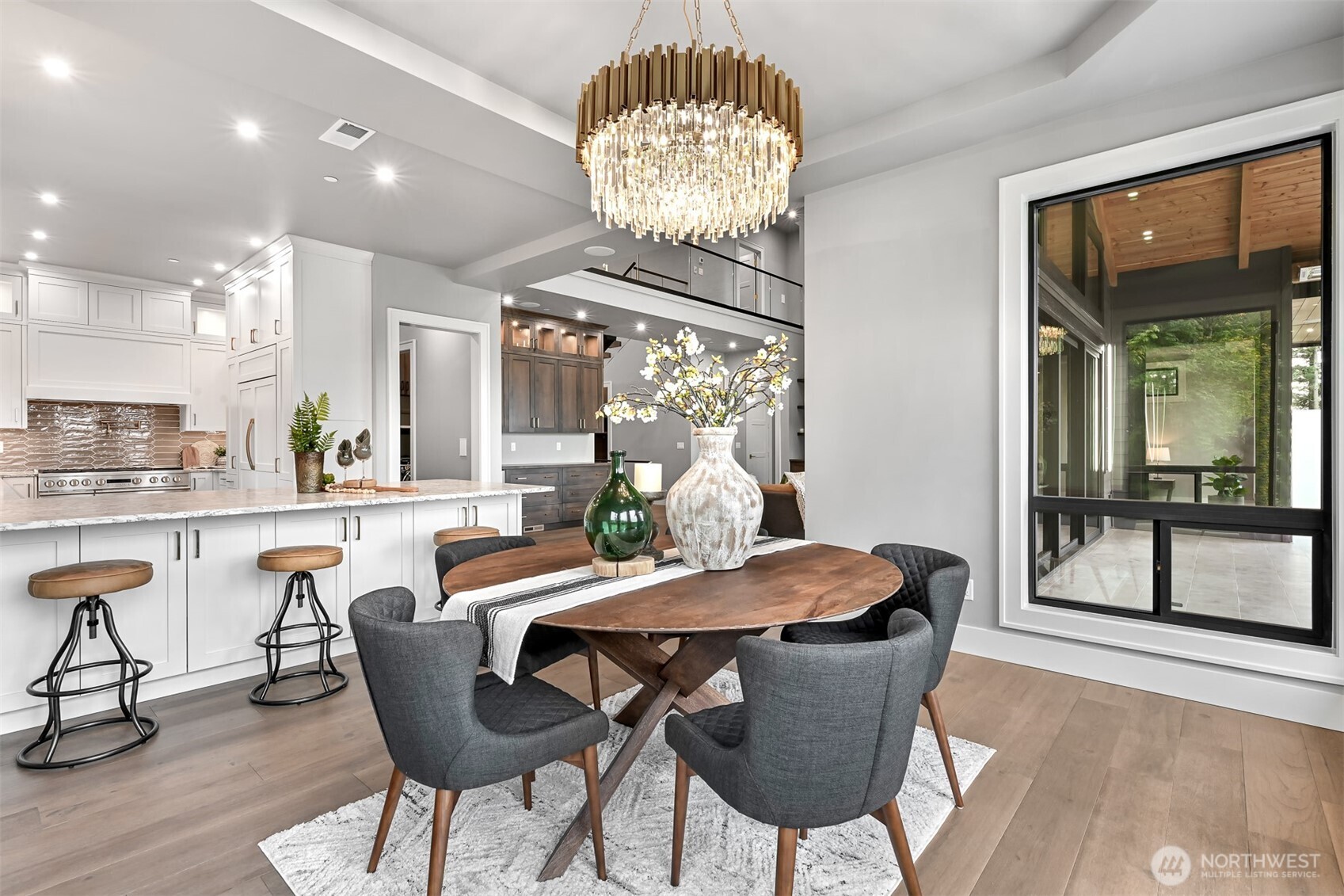 555 Whitecap Road Bellingham, WA 98229 - Photo 22 of 40 a dining room with furniture a potted plant and a chandelier