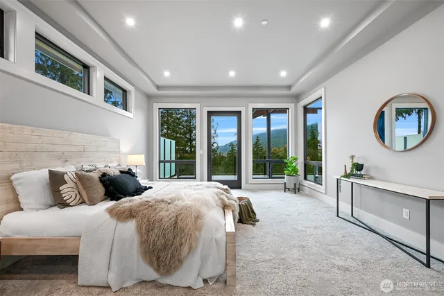 a bedroom with a large bed and a large window