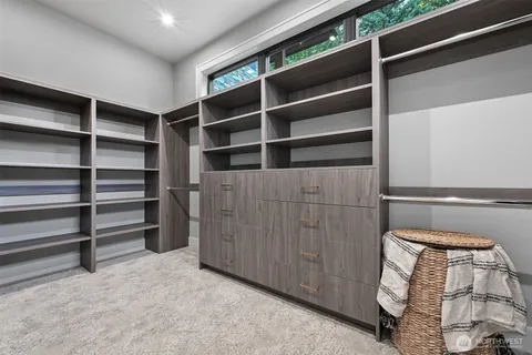 a view of walk in closet with empty racks