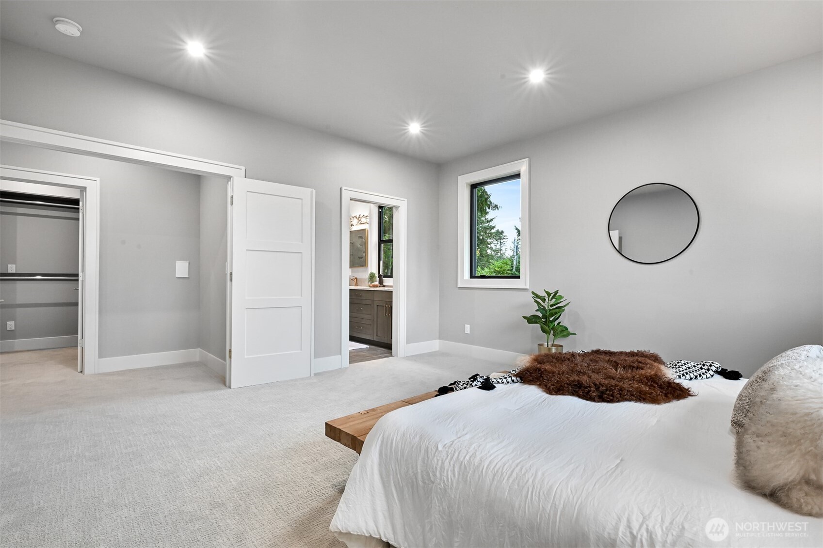 555 Whitecap Road Bellingham, WA 98229 - Photo 31 of 40 a bedroom with a bed and a chandelier